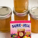 dandelion jelly in jars with a box of sure jell