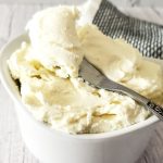 homemade cream cheese in a bowl with a knife