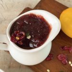 cranberry sauce in a pitcher on a board