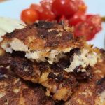 a close up of a tuna fritter on a plate