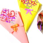 Colorful paper cones embellished with heart stamp bouquets and small bow ties.