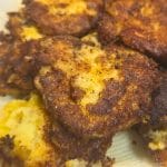 Several golden-brown, crispy mashed potato cakes rest on a paper towel, likely to absorb excess oil.